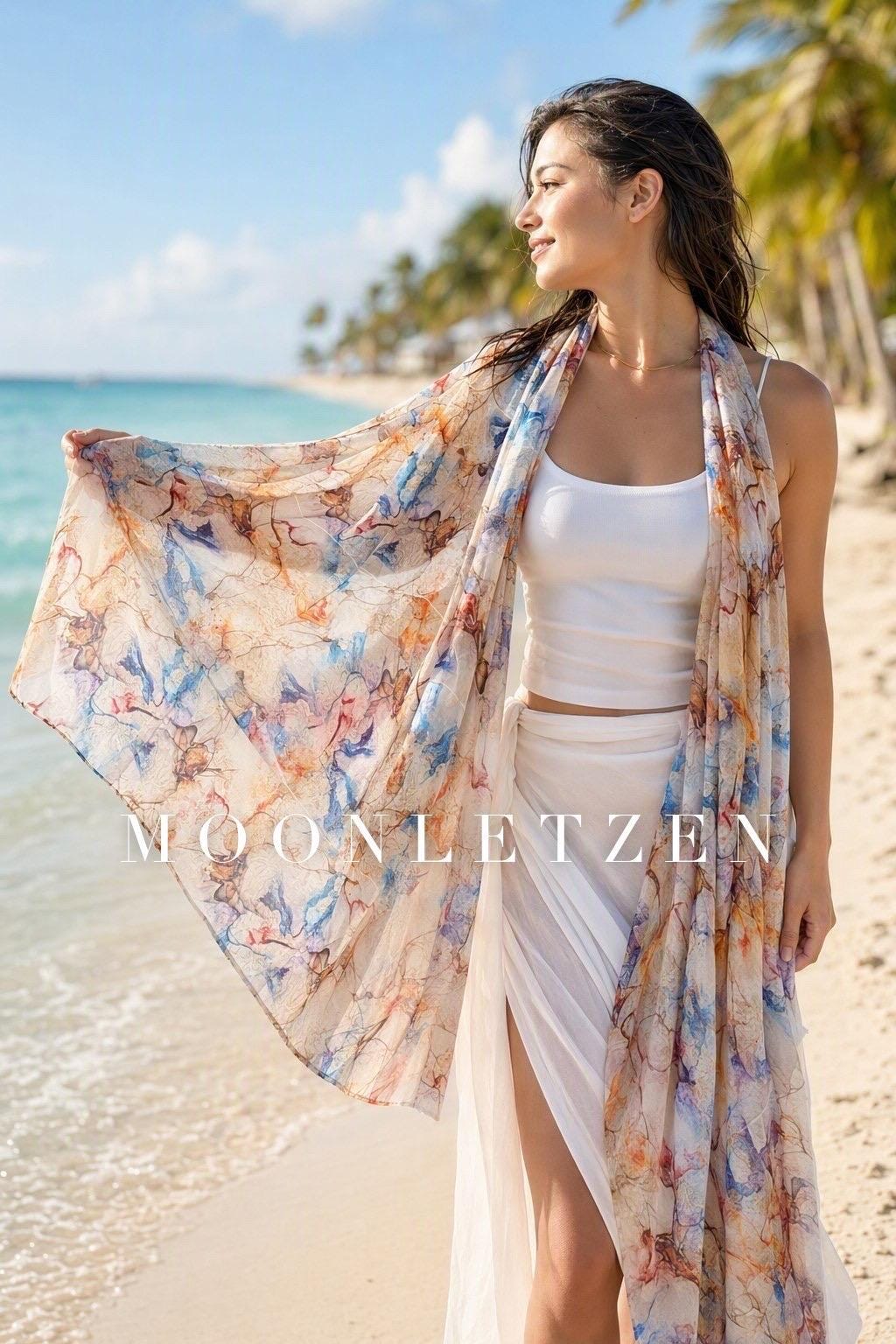 Sheer blue silk shawl with flowing amber and smoky quartz watercolor marble patterns.