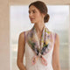 Pale floral silk neckerchief with lilac lace trim tied over a white top.