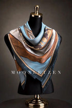 Celadon blue silk square scarf with rosette medallions and amber-gold ornamental borders.