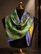 Green, violet and yellow floral silk scarf draped around a black mannequin.