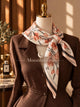 Ivory silk square scarf with muted coral, blush, grey and charcoal floral motifs.