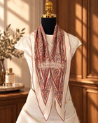 Burgundy paisley diamond-shaped silk scarf with ivory, muted blue and gold details.